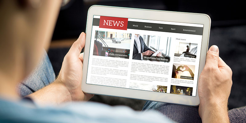 Online news article on tablet screen. Electronic newspaper or magazine. Latest daily press and media. Mockup of digital portal and website. Happy person using web service in the morning.